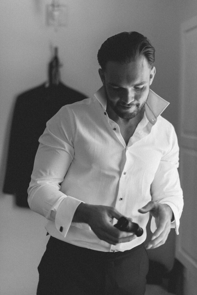Black and white portrait of a groom getting ready on his wedding day