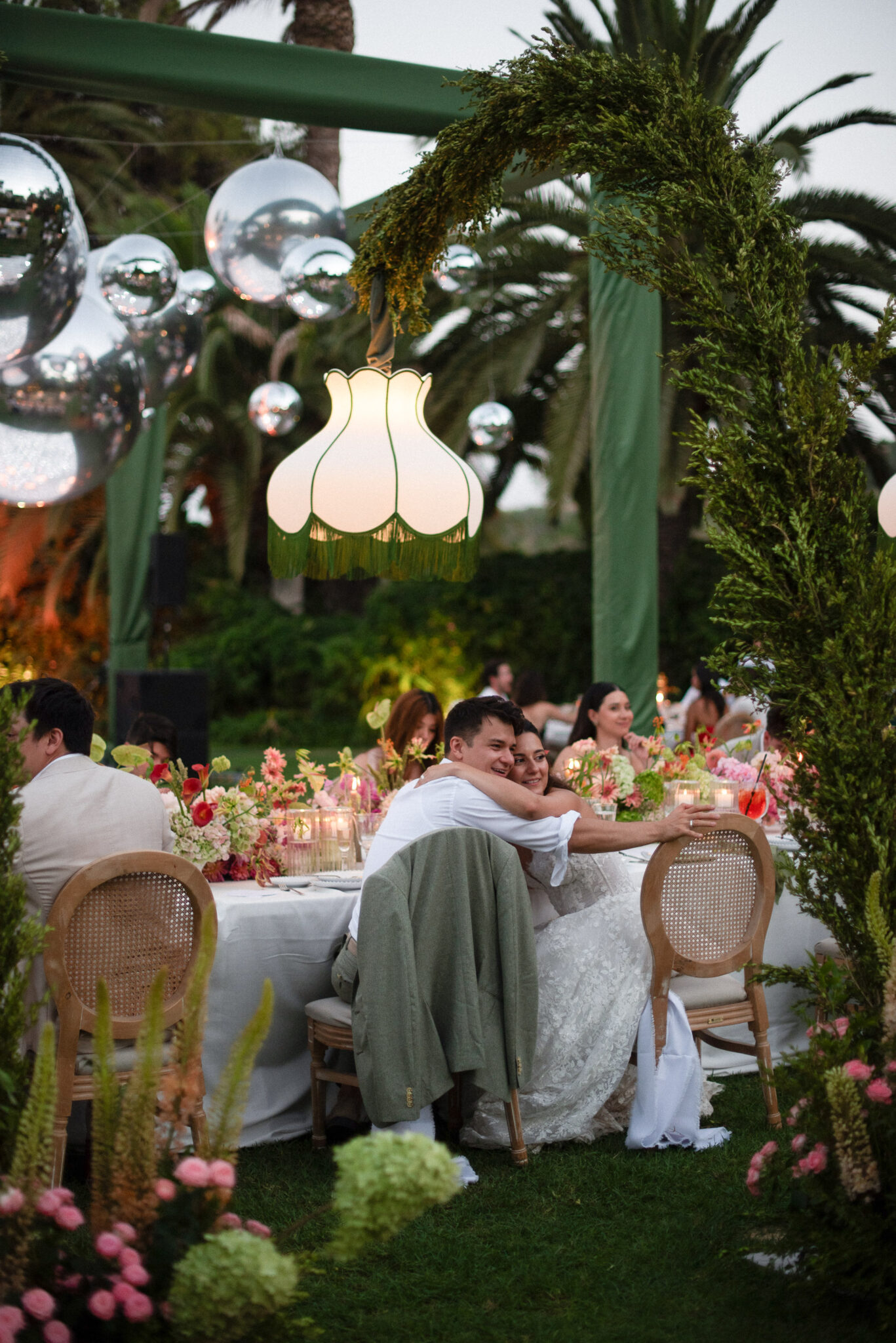 Couple embracing during an outdoor wedding dinner in Marbella, Spain