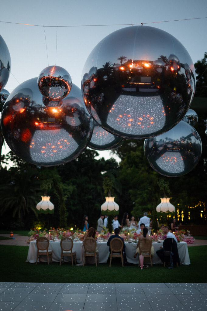 Disco balls and guests at an evening wedding celebration in Marbella