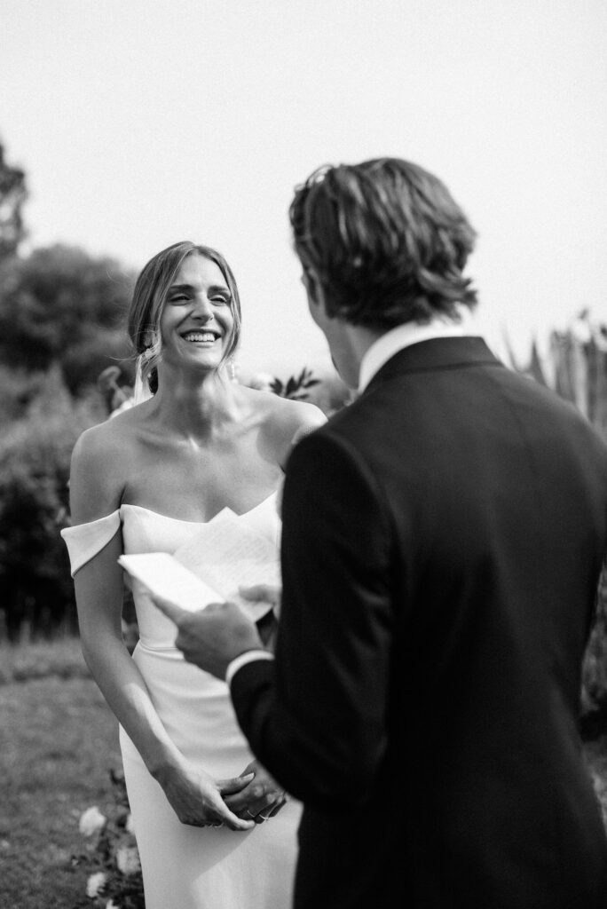 Candid black and white portrait of a bride laughing on her wedding day in La Toscana