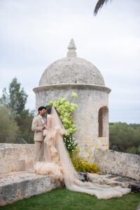 Couple walking through the Mediterranean landscape at a destination wedding in Menorca